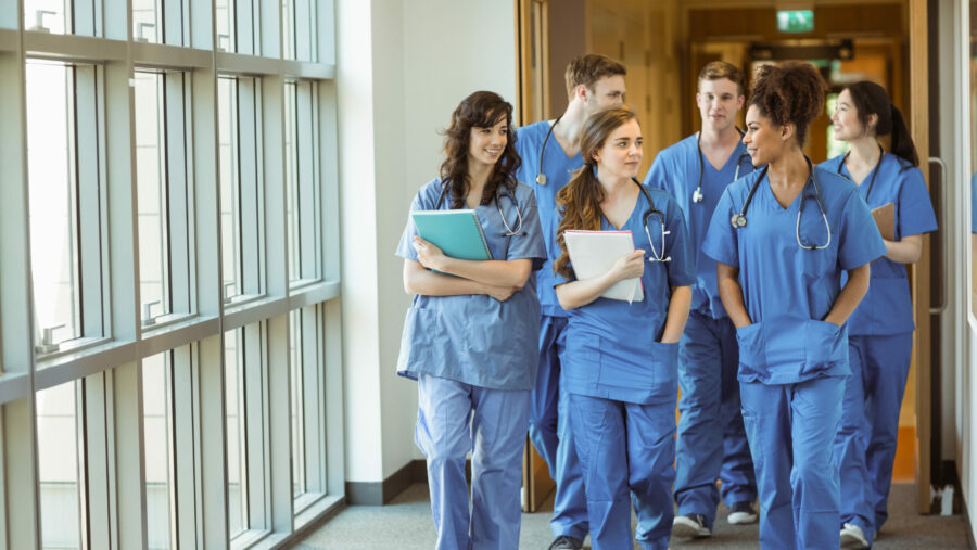 Medical,Students,Walking,Through,Corridor,At,The,University